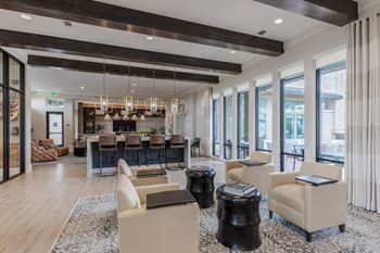 A modern living room with a bar area and a dining table.